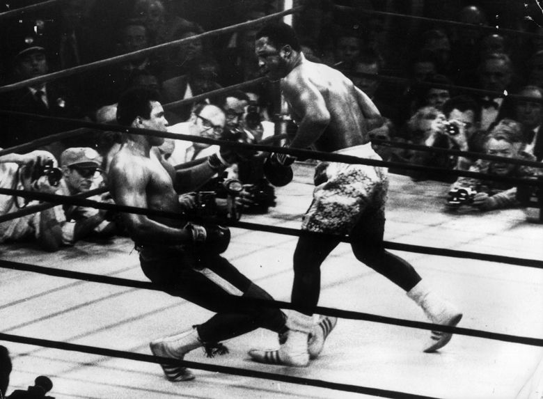 March 1971:  In a title fight at Madison Square Gardens, New York, Muhammad Ali goes down in the 15th round to a left hook from world heavyweight champion Joe Frazier who kept the title with an unanimous points win. Cameramen are crowded round the ring.  (Photo by Keystone/Getty Images)