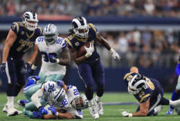 ARLINGTON, TX - OCTOBER 01:  Todd Gurley #30 of the Los Angeles Rams runs the ball past Jeff Heath #38 and Brian Price #92 of the Dallas Cowboys in the third quarter at AT&amp;T Stadium on October 1, 2017 in Arlington, Texas.  (Photo by Ronald Martinez/Getty Images)