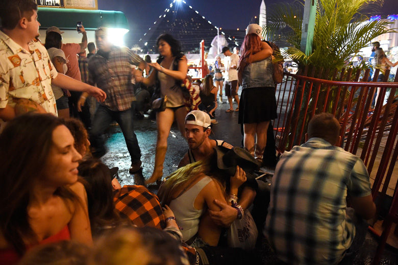 LAS VEGAS, NV - OCTOBER 01:   People run for cover at the Route 91 Harvest country music festival after apparent gun fire was heard on October 1, 2017 in Las Vegas, Nevada. There are reports of an active shooter around the Mandalay Bay Resort and Casino.  (Photo by David Becker/Getty Images)