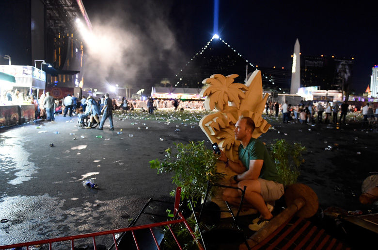 LAS VEGAS, NV - OCTOBER 01:  A person  takes cover at the Route 91 Harvest country music festival after apparent gun fire was heard on October 1, 2017 in Las Vegas, Nevada.  There are reports of an active shooter around the Mandalay Bay Resort and Casino.  (Photo by David Becker/Getty Images)