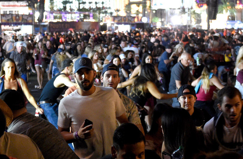 LAS VEGAS, NV - OCTOBER 01:  People flee the Route 91 Harvest country music festival grounds after a active shooter was reported on October 1, 2017 in Las Vegas, Nevada. A gunman has opened fire on a music festival in Las Vegas, leaving at least 2 people dead. Police have confirmed that one suspect has been shot. The investigation is ongoing. (Photo by David Becker/Getty Images)