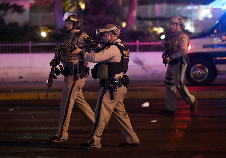 LAS VEGAS, NV - OCTOBER 02:  Police officers point their weapons at a car driving down closed Tropicana Ave. near Las Vegas Boulevard after a reported mass shooting at a country music festival nearby on October 2, 2017 in Las Vegas, Nevada.  A gunman has opened fire on a music festival in Las Vegas, leaving at least 2 people dead. Police have confirmed that one suspect has been shot. The investigation is ongoing. (Photo by Ethan Miller/Getty Images)