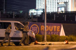 LAS VEGAS, NV - OCTOBER 02:  Las Vegas police run by a banner on the fence at the Route 91 Harvest country music festival grounds after a active shooter was reported on October 2, 2017 in Las Vegas, Nevada. A gunman has opened fire on a music festival in Las Vegas, leaving at least 20 people dead and more than 100 injured. Police have confirmed that one suspect has been shot. The investigation is ongoing. (Photo by David Becker/Getty Images)