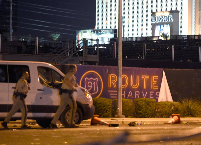 LAS VEGAS, NV - OCTOBER 02:  Las Vegas police run by a banner on the fence at the Route 91 Harvest country music festival grounds after a active shooter was reported on October 2, 2017 in Las Vegas, Nevada. A gunman has opened fire on a music festival in Las Vegas, leaving at least 20 people dead and more than 100 injured. Police have confirmed that one suspect has been shot. The investigation is ongoing. (Photo by David Becker/Getty Images)