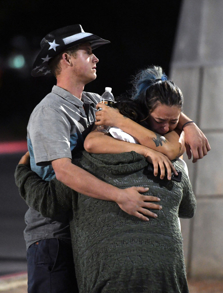 LAS VEGAS, NV - OCTOBER 02:  People hug and cry outside the Thomas &amp; Mack Center after a mass shooting at the Route 91 Harvest country music festival on October 2, 2017 in Las Vegas, Nevada. A gunman, identified as Stephen Paddock, 64, of Mesquite, Nevada, opened fire from the Mandalay Bay Resort and Casino on the music festival, leaving at least 50 people dead and hundreds injured. Police have confirmed that one suspect has been shot. The investigation is ongoing.  (Photo by Ethan Miller/Getty Images)