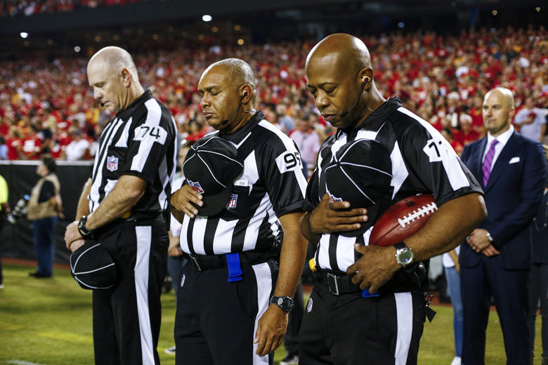 KANSAS CITY, MO - OCTOBER 2: Referees bow their heads during a moment of silence for the victims of the Las Vegas shootings before the game between the Washington Redskins and the Kansas City Chiefs at Arrowhead Stadium on October 2, 2017 in Kansas City, Missouri. ( Photo by Jamie Squire/Getty Images )