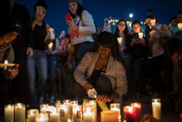 LAS VEGAS, NV - OCTOBER 2: Mourners light candles during a vigil at the corner of Sahara Avenue and Las Vegas Boulevard  for the victims of Sunday night's mass shooting, October 2, 2017 in Las Vegas, Nevada. Late Sunday night, a lone gunman killed more than 50 people and injured more than 500 people after he opened fire on a large crowd at the Route 91 Harvest Festival, a three-day country music festival. The massacre is one of the deadliest mass shooting events in U.S. history. (Photo by Drew Angerer/Getty Images)