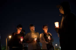 LAS VEGAS, NV - OCTOBER 3: At the corner of Sunset Road and Las Vegas Blvd., mourners attend a candlelight vigil for the victims of Sunday night's mass shooting, October 3, 2017 in Las Vegas, Nevada. Late Sunday night, a lone gunman killed over 50 people and injured over 500 people after he opened fire on a large crowd at the Route 91 Harvest country music festival. The massacre is one of the deadliest mass shooting events in U.S. history. (Photo by Drew Angerer/Getty Images)