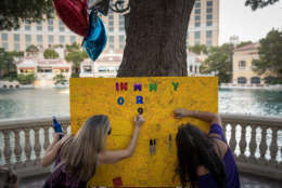 LAS VEGAS, NV - OCTOBER 3: Pedestrians on the Las Vegas Strip stop and write messages at a makeshift memorial for the victims of Sunday night's mass shooting, in front to the Bellagio, October 3, 2017 in Las Vegas, Nevada. Late Sunday night, a lone gunman killed over 50 people and injured over 500 people after he opened fire on a large crowd at the Route 91 Harvest Festival, a three-day country music festival. The massacre is one of the deadliest mass shooting events in U.S. history. (Photo by Drew Angerer/Getty Images)