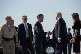 LAS VEGAS, NV - OCTOBER 4: Clark County Sheriff Joe Lombardo (L) and first lady Melania Trump look on as Nevada Governor Brian Sandoval shakes hands with President Donald Trump upon arrival at McCarran International Airport, October 4, 2017 in Las Vegas, Nevada. Trump is scheduled to visit with victims  and first responders from Sunday night's mass shooting during his trip to Las Vegas. (Photo by Drew Angerer/Getty Images)