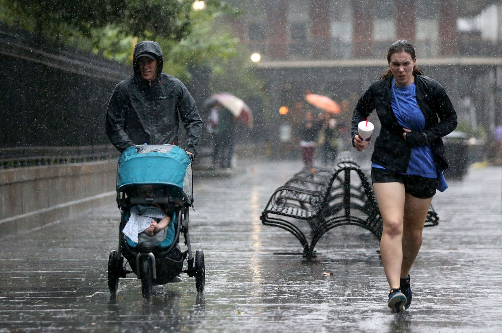 NEW ORLEANS, LA - OCTOBER 07:  Tourists run to avoid the rain as strong winds and heavy rain from Hurricane Nate begin to come ashore on October 7, 2017 in New Orleans, Louisiana.  Nate is expected to make landfall as a category 2 hurricane near Biloxi, Mississippi later this evening.  (Photo by Sean Gardner/Getty Images)