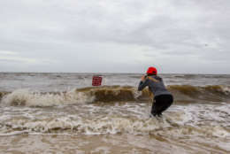 GULFPORT,MS-OCTOBER 7, 2017: Hannah Jacole Powell-Yost takes photos of a danger sign in the Gulf surf in Gulfport, Mississippi as Hurricane Nate approaches the northern Mississippi Gulf Coast on October 7, 2017 in Gulfport, Mississippi. October 7, 2017. Nate is expected to make landfall in the overnight hours as a category 2 storm. (Photo by Mark Wallheiser/Getty Images)