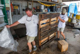 BAYOU LA BATRE, AL - OCTOBER 8:  Greg Marshall (L) and Kyle Porter clean up Marshall Marine after the store took three feet of storm surge from Hurricane Nate on October 8, 2017 in Bayou La Batre, Alabama.  Hurricane Nate made its second landfall along the north Mississippi Gulf Coast as a category 1 hurricane Sunday before weakening to a tropical storm.  (Photo by Mark Wallheiser/Getty Images)