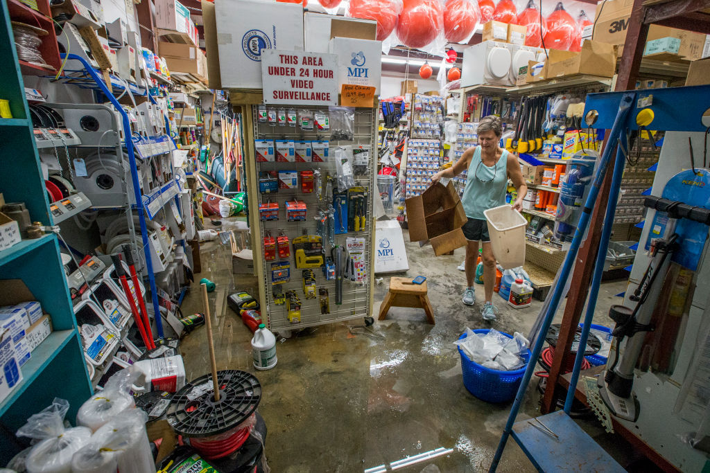 BAYOU LA BATRE, AL - OCTOBER 8:  Tara Marshall cleans up Marshall Marine after the store took three feet of storm surge from Hurricane Nate on October 8, 2017 in Bayou La Batre, Alabama.  Hurricane Nate made its second landfall along the north Mississippi Gulf Coast as a category 1 hurricane Sunday before weakening to a tropical storm.  (Photo by Mark Wallheiser/Getty Images)