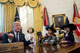 WASHINGTON, DC - OCTOBER 27: U.S. President Donald Trump meets with children of journalists and White House staffers in the Oval Office at the White House, October 27, 2017 in Washington, DC. The children were dressed in costume for Halloween.  (Drew Angerer/Getty Images)