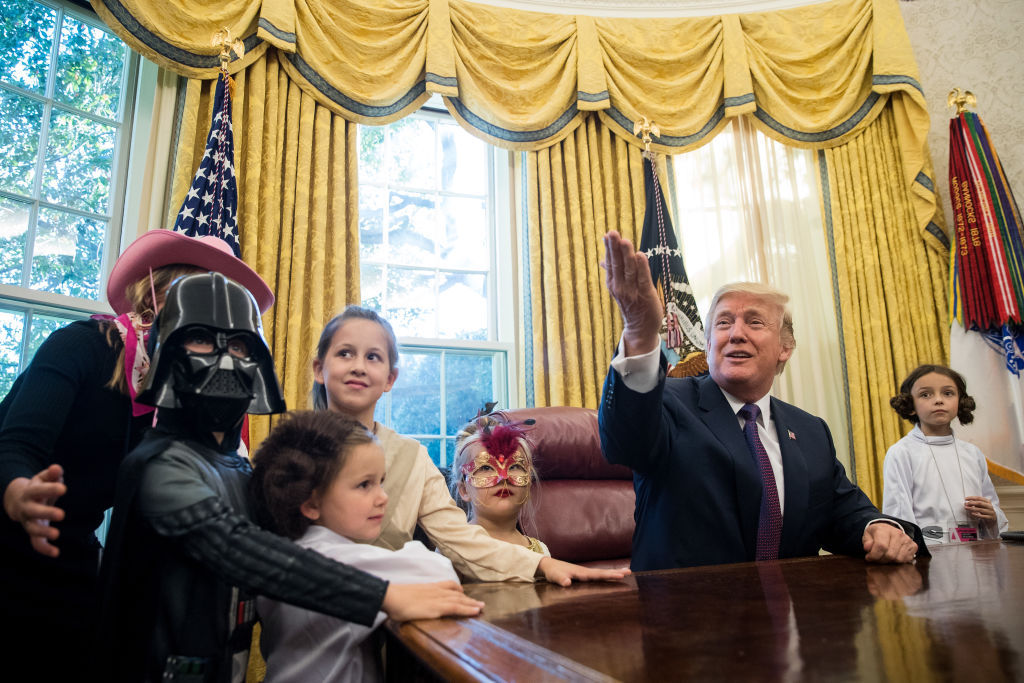 WASHINGTON, DC - OCTOBER 27: U.S. President Donald Trump meets with children of journalists and White House staffers in the Oval Office at the White House, October 27, 2017 in Washington, DC. The children were dressed in costume for Halloween.  (Drew Angerer/Getty Images)