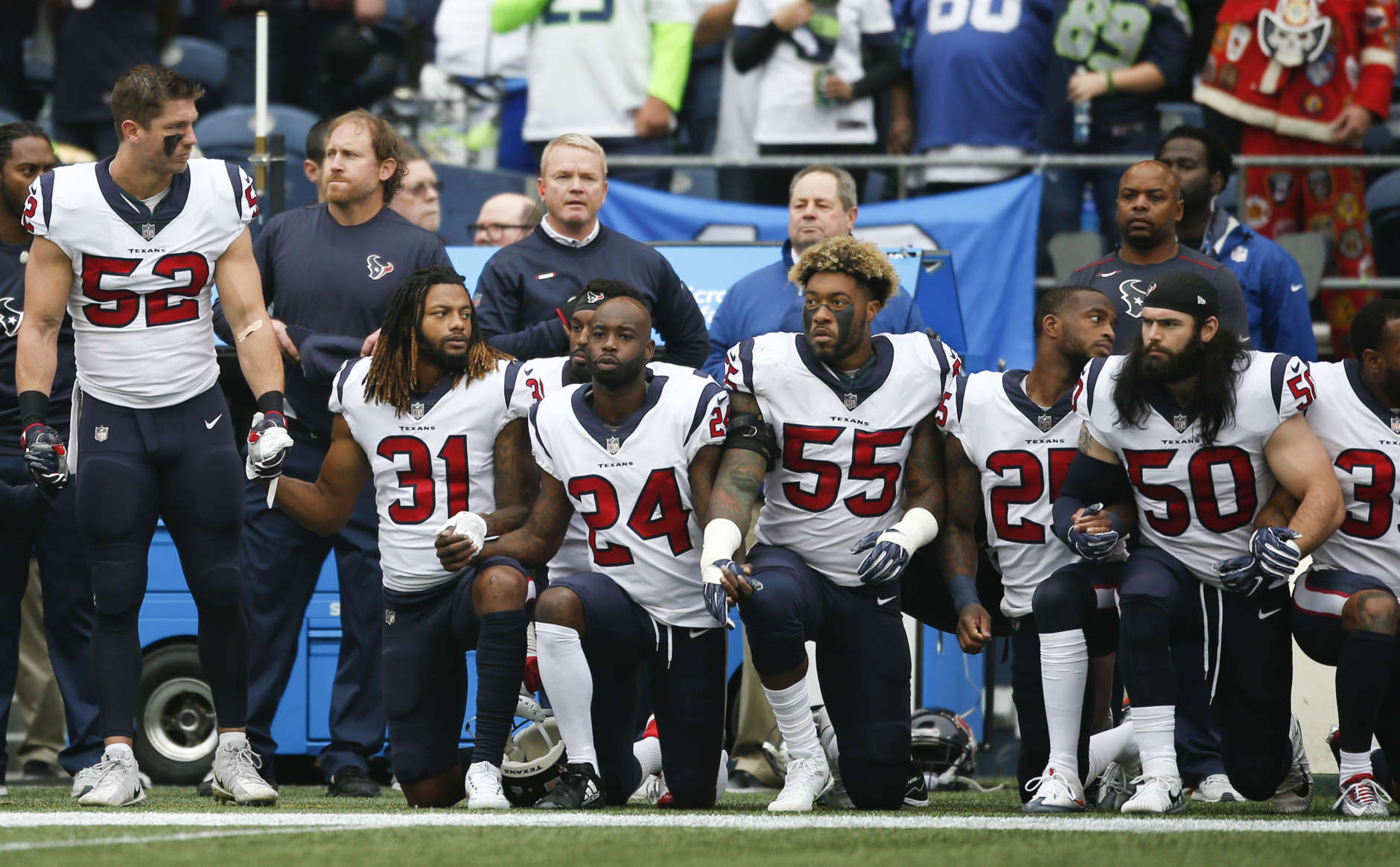 SEATTLE, WA - OCTOBER 29:  Members of the Houston Texans stand and kneel before the game against the Seattle Seahawks at CenturyLink Field on October 29, 2017 in Seattle, Washington. During a meeting of NFL owners earlier in October, Houston Texans owner Bob McNair said "we can't have the inmates running the prison", referring to player demonstrations during the national anthem. (Photo by Otto Greule Jr/Getty Images)