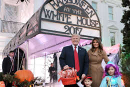 WASHINGTON, DC - OCTOBER 30:  U.S. President Donald Trump (L) and first lady Melania Trump pose for photographs while hosting Halloween at the White House on the South Lawn October 30, 2017 in Washington, DC. The first couple gave cookies away to costumed trick-or-treaters one day before the Halloween holiday.  (Photo by Chip Somodevilla/Getty Images)