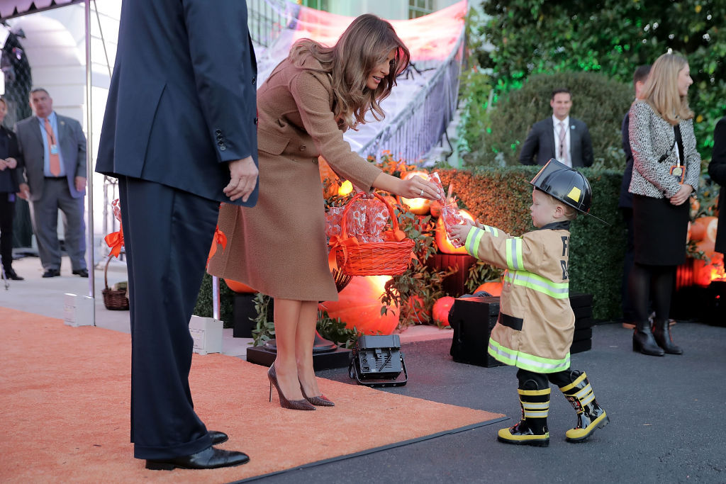 WASHINGTON, DC - OCTOBER 30:  U.S. first lady Melania Trump gives a cookie to little trick-or-treater while hosting Halloween at the White House on the South Lawn October 30, 2017 in Washington, DC. The first couple gave cookies away to costumed trick-or-treaters one day before the Halloween holiday.  (Photo by Chip Somodevilla/Getty Images)