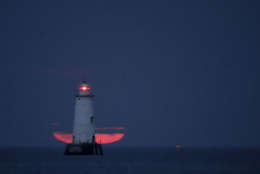 The Great Bends Lighthouse is seen as a thick cloud layer obstructs the view of the full moon rising over the Raritan Bay, Thursday, Oct. 5, 2017, in South Amboy, N.J. The moon, better known as the Harvest Moon because it's the first full moon during the fall season, had not risen in its full stage during the month of October since 2009. (AP Photo/Julio Cortez)