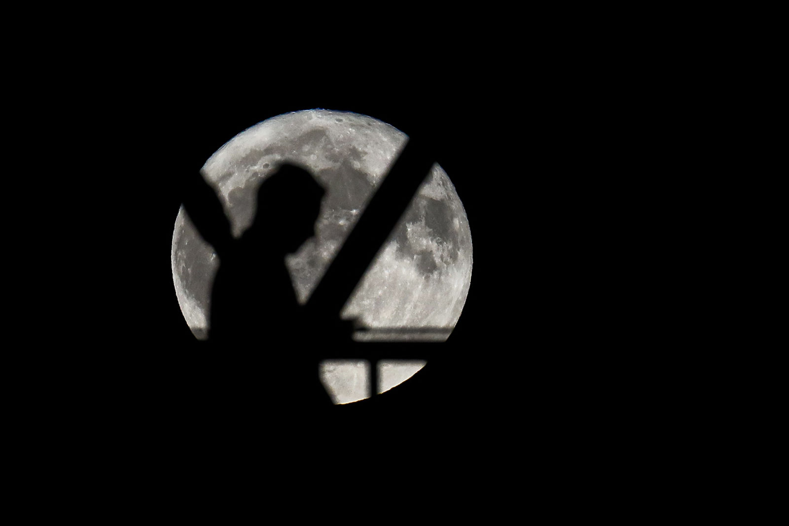 A pedestrian crosses over the John A. Roebling Suspension Bridge as the full moon rises, Thursday, Oct. 5, 2017, in Cincinnati. The moon, better known as the Harvest Moon because it's the first full moon during the fall season, had not risen in its full stage during the month of October since 2009. (AP Photo/John Minchillo)