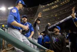 Chicago Cubs starting pitcher Kyle Hendricks, left, is greeted by teammates in the dugout at the end of the seventh inning in Game 1 of baseball's National League Division Series against the Washington Nationals at Nationals Park, Friday, Oct. 6, 2017, in Washington. (AP Photo/Pablo Martinez Monsivais)