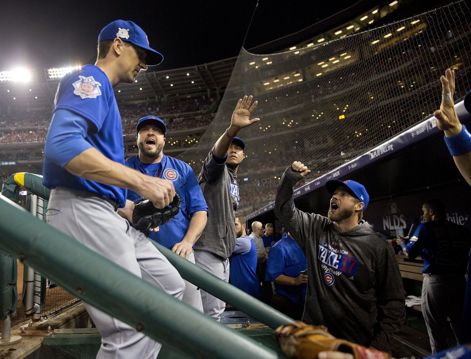 Chicago Cubs starting pitcher Kyle Hendricks, left, is greeted by teammates in the dugout at the end of the seventh inning in Game 1 of baseball's National League Division Series against the Washington Nationals at Nationals Park, Friday, Oct. 6, 2017, in Washington. (AP Photo/Pablo Martinez Monsivais)
