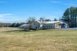 The property also includes an 11,200-square-foot indoor riding arena, two show arenas and stables and offers boarding and training. (Courtesy Auction Markets LLC)