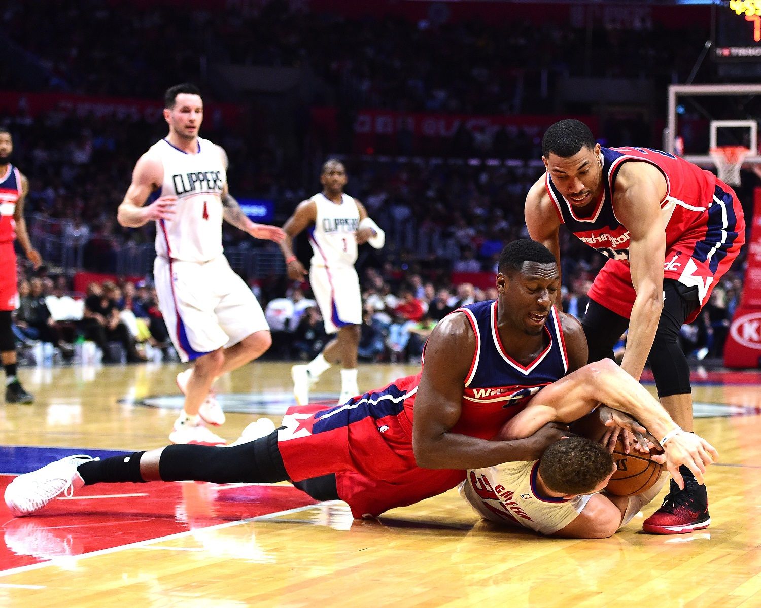 LOS ANGELES, CA - MARCH 29:  Ian Mahinmi #28 and Otto Porter Jr. #22 of the Washington Wizards surround Blake Griffin #32 of the LA Clippers on the floor during a 133-124 Clipper win at Staples Center on March 29, 2017 in Los Angeles, California.  NOTE TO USER: User expressly acknowledges and agrees that, by downloading and or using this photograph, User is consenting to the terms and conditions of the Getty Images License Agreement.  (Photo by Harry How/Getty Images)