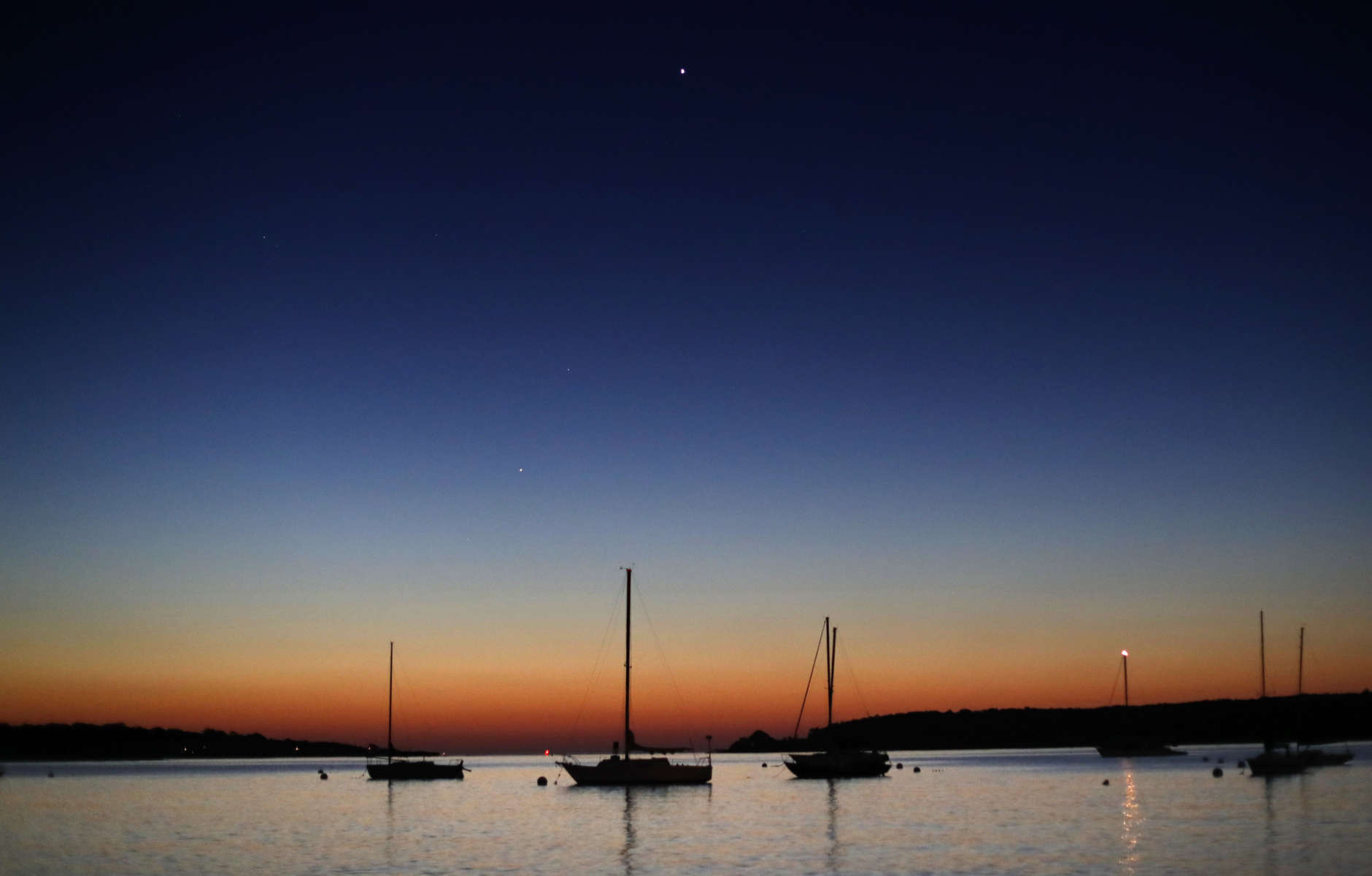 The planets Venus, top center, and Mars, lower left, rise in the eastern sky before sunrise off Willard Beach, Wednesday, Sept. 13, 2017, in South Portland, Maine. (AP Photo/Robert F. Bukaty)