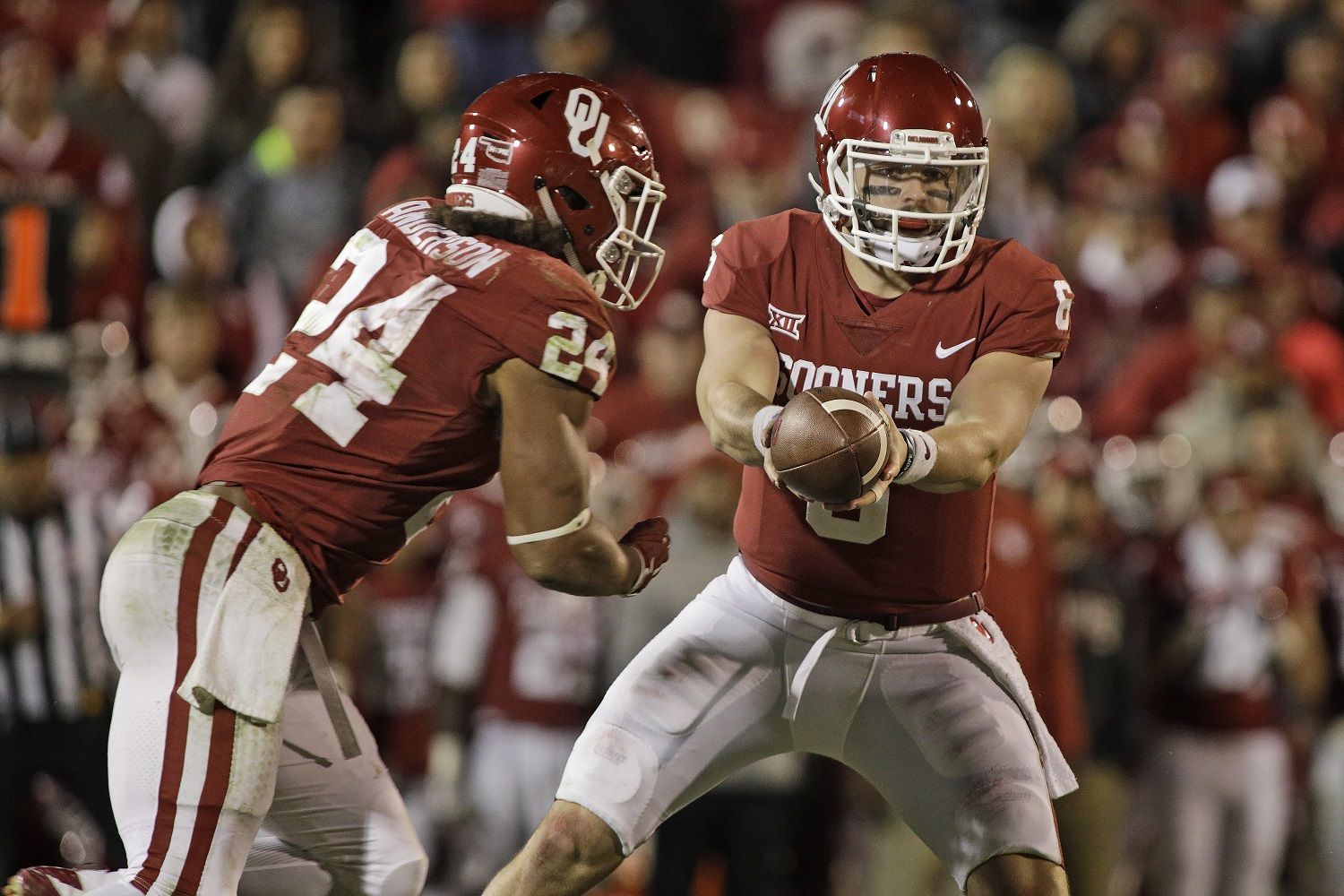 NORMAN, OK - OCTOBER 28: Quarterback Baker Mayfield #6 hands off to running back Rodney Anderson #24 of the Oklahoma Sooners at Gaylord Family Oklahoma Memorial Stadium on October 28, 2017 in Norman, Oklahoma. Oklahoma defeated Texas Tech 49-27. (Photo by Brett Deering/Getty Images)