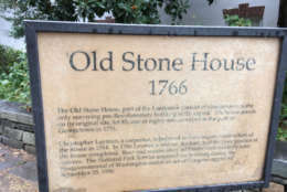 The plaque that was placed by the house around the centenntial of the American Revolution and the the centennial of Washington D.C. played a big role in saving the house from demolition. (WTOP/Liz Anderson)