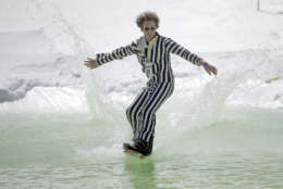 Corey Turnbull, dressed as beetlejuice, competes during the annual pond skimming contest Saturday, April 15, 2017, at Park City Mountain, in Park City, Utah. Contestants must dress in costume as they attempt to cross a 100-foot pond on skis or a snowboard. (AP Photo/Rick Bowmer)
