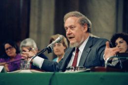Supreme Court Justice nominee Robert H. Bork gestures as he testifies on Capitol Hill, before the Senate Judiciary Committee holding his confirmation hearings, Sept. 16, 1987. Bork denied that he acted illegally in firing special Watergate prosecutor Archibald Cox 14 years ago. (AP Photo/John Duricka)