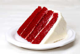 Slice of red velvet cake on plate.