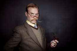 eccentric male with pipe in vintage clothing.