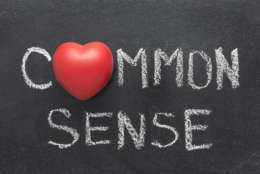 common sense exclamation handwritten on blackboard with heart symbol instead of O