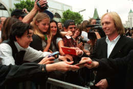 Rock star Tom Petty signs autographs after his band, Tom Petty and the Heartbreakers, were honored Wednesday, April 28, 1999, with the 2,133rd star on the Hollywood Walk of Fame in the Hollywood section of Los Angeles. Tom Petty and the Heartbreakers has sold over 30 million albums, won Grammys and MTV awards and produced over 25 classic hits. Their latest album "Echo" which was released on April 13th debuted this week at number 10 on the Billboard album chart. (AP Photo/Damian Dovarganes)