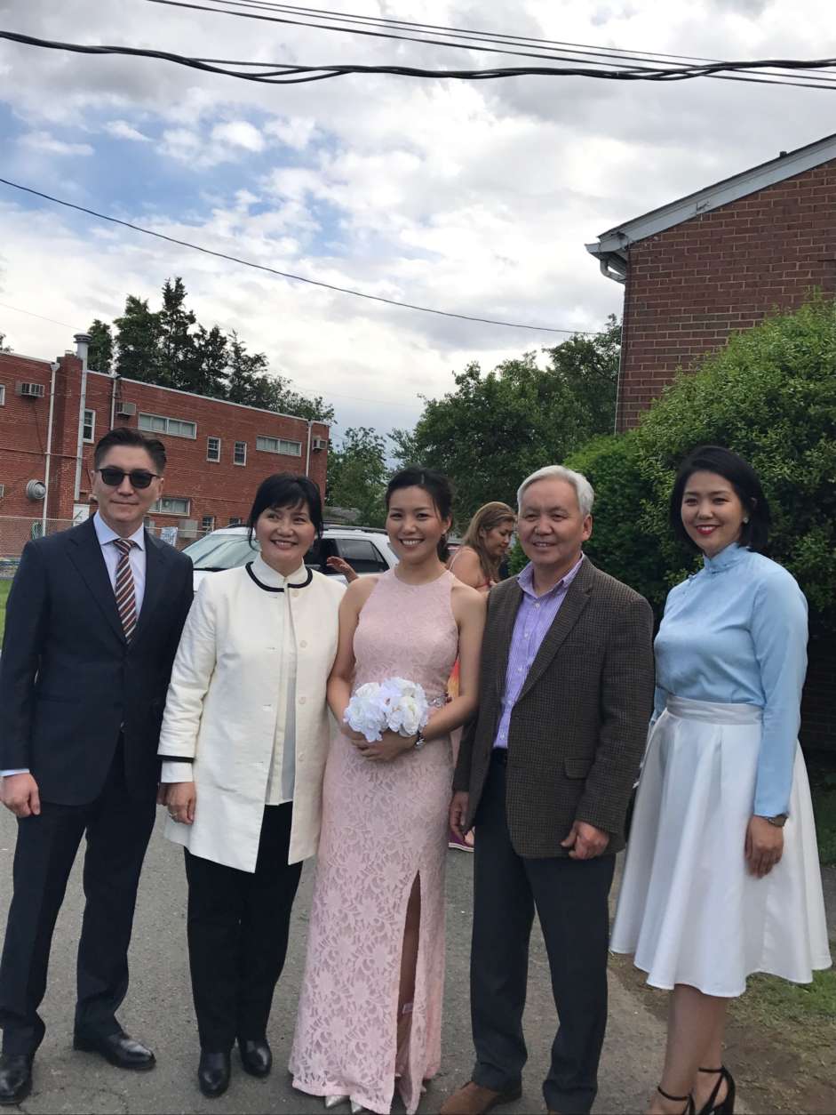 Bayarsaikhan Tudev was one of three people shot and killed Wednesday at a granite manufacturer in Edgewood, Maryland. He is photographed here (2nd from left) at a wedding with his daughter and wife. (Courtesy NBC Washington via Tudev family) 