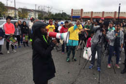 At least 100 people marched through Southeast D.C. on Saturday, calling for more grocery stores in Ward 8. (WTOP/John Domen)