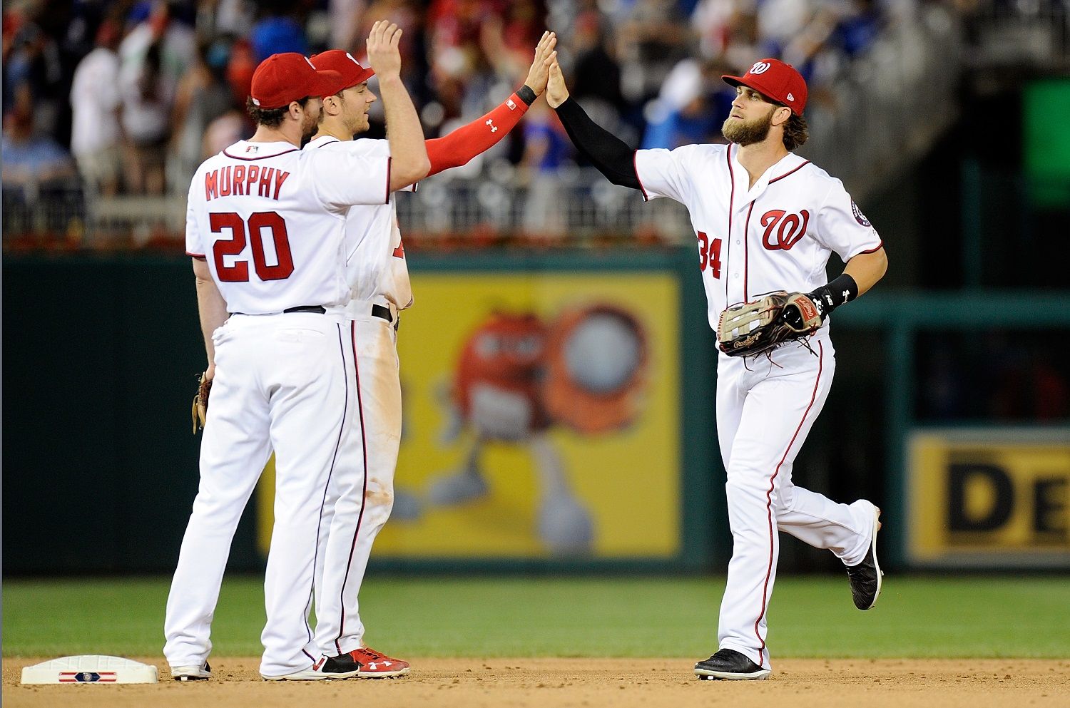 WASHINGTON, DC - JUNE 27: Bryce Harper #34 of the Washington Nationals celebrates with Trea Turner #7 and Daniel Murphy #20 after a 6-1 victory against the Chicago Cubs at Nationals Park on June 27, 2017 in Washington, DC.  (Photo by Greg Fiume/Getty Images)