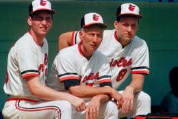 Cal Ripken Sr., center, poses with his sons Billy Ripken, left, and Cal Jr., at the Baltimore Orioles training camp in Miami, Fla., Feb. 27, 1987.  Ripken Sr. is the new Orioles manager. Cal Jr., 26, has become a major league superstar at shortstop in five full seasons with the team.  Billy, 21, is trying to make the team as second baseman after a solid season at Class AA in Charlotte, N.C.  (AP Photo/Joe Skipper)