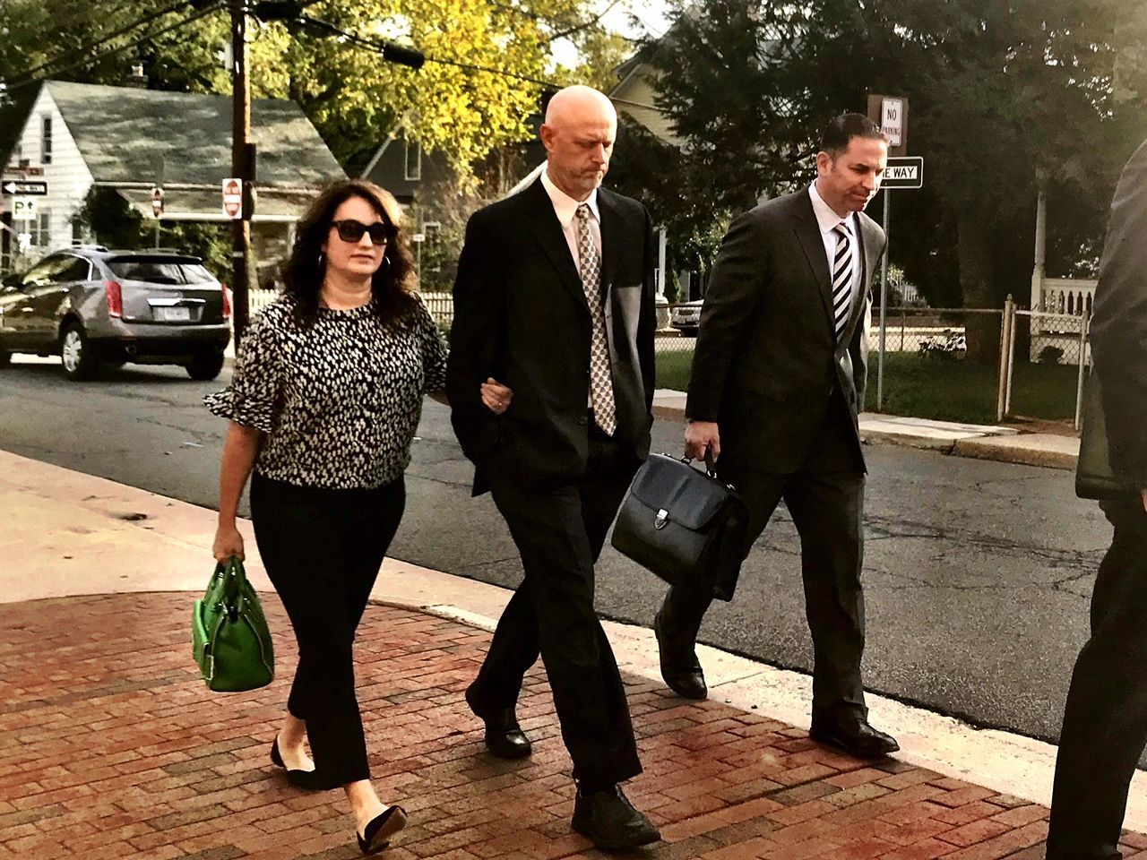 John Miller IV (center), with his wife and attorney, entering the Loudoun County Courthouse. Miller was found guilty of reckless driving in the crash that killed Tristan Schulz. (WTOP/Neal Augenstein)
