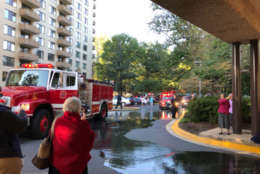 Firefighters helped residents evacuate due to the amount of smoke. (WTOP/Bruce Alan)
