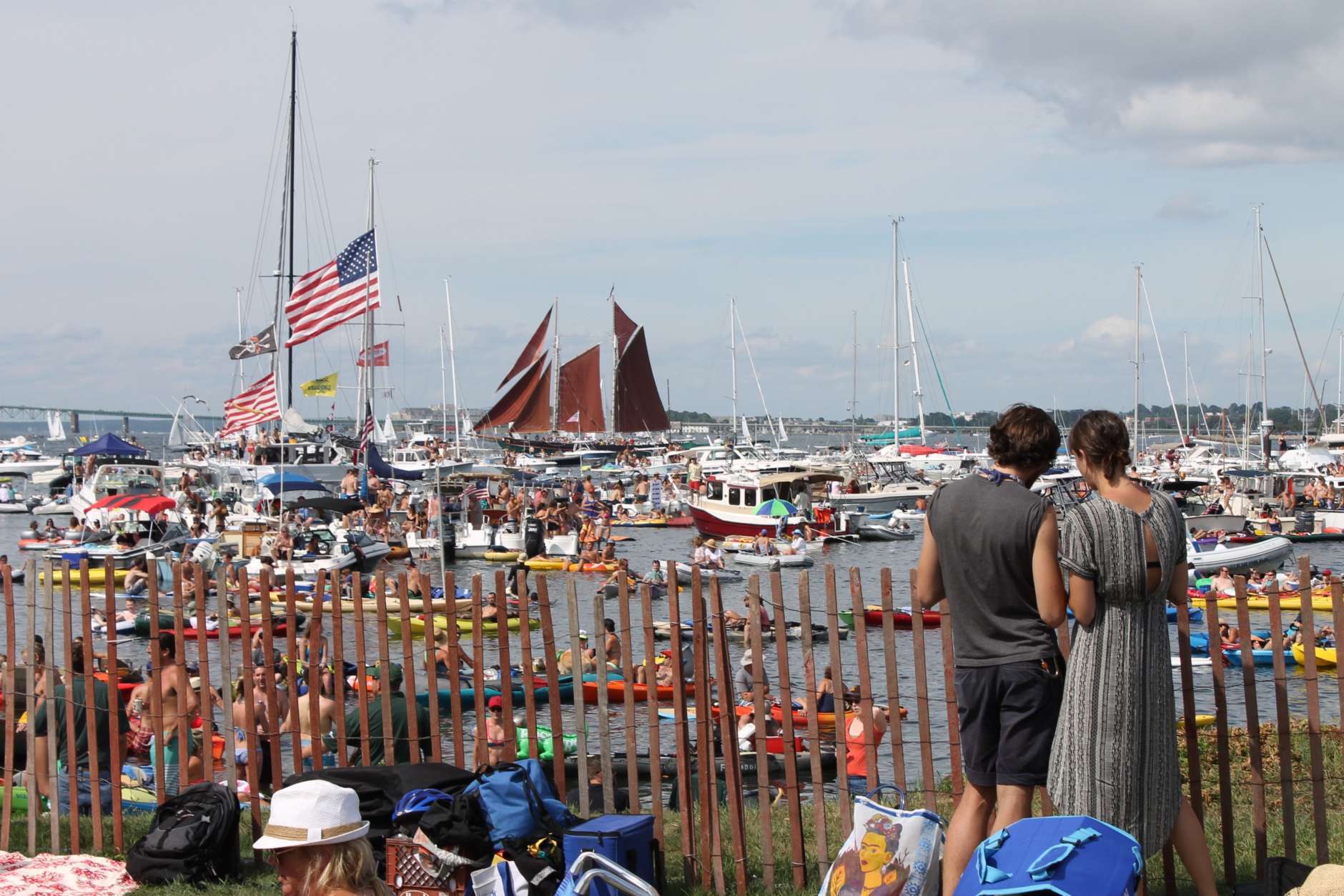 Attendees at the Newport Folk Festival look out at the harbor Saturday, July 25, 2015, during the second day of the three-day festival at Fort Adams State Park in Newport, R.I. (AP Photo/Michelle R. Smith)