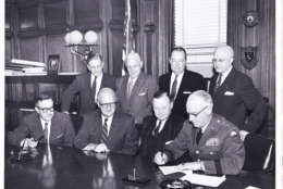 This Dec. 12, 1958 photo shows officials with the Interior Department signing over a 30-year-lease for the land the future stadium would sit on to the D.C. Armory Board. (Courtesy EventsDC)