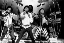 Four of the Jacksons, from left, Tito, Michael, Marlon, on drums, and Randy, are shown performing during their Victory Tour concert at RFK Stadium in Washington, D.C., on Sept. 22, 1984.  (AP Photo/Bill Auth)