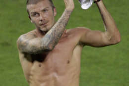 ** RETRANSMISSION FOR ALTERNATE CROP ** Los Angeles Galaxy's midfielder David Beckham, applauds the sellout crowd of over 45,000 at RFK Stadium as he walks of the field shirtless after making his MLS debut against DC United, Thursday, Aug, 9, 2007 in Washington. Beckham came in as a second half substitute in the galaxy's 1-0 loss. (AP Photo/Pablo Martinez Monsivais)