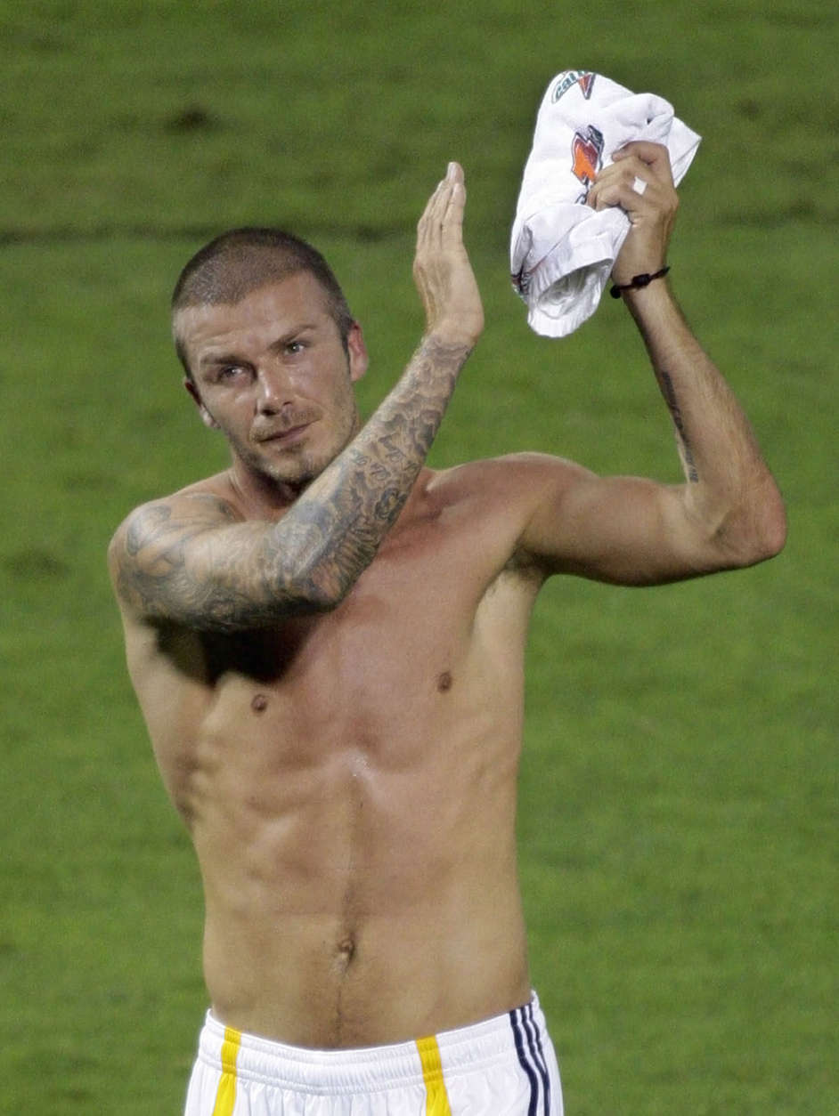 ** RETRANSMISSION FOR ALTERNATE CROP ** Los Angeles Galaxy's midfielder David Beckham, applauds the sellout crowd of over 45,000 at RFK Stadium as he walks of the field shirtless after making his MLS debut against DC United, Thursday, Aug, 9, 2007 in Washington. Beckham came in as a second half substitute in the galaxy's 1-0 loss. (AP Photo/Pablo Martinez Monsivais)