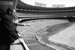 Washington Redskins coach George Allen left, and Bob Singholtz, general manager of the D.C. Armory Board, look over the field at Robert F. Kennedy stadium in Washington on Friday, March 28, 1975 which is being prepared for the installation of Prescription Athletic Turf. (AP Photo)